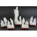 A 20th century Chinese porcelain Blanc de Chine figure of Guan Yin on carved wooden stand and four