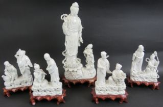 A 20th century Chinese porcelain Blanc de Chine figure of Guan Yin on carved wooden stand and four