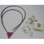 A pink triangular pendant on granite base with 'Cliclasp' and alternative stranded necklace with