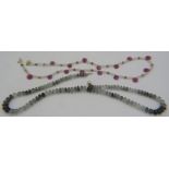 A pink sapphire briolette & white quartz necklace interspersed with small yellow metal beads and