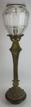 An early 20th century gilt brass newel post lantern with heavy cut glass shade mounted on a tri-form