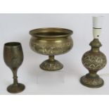 Three pieces on Indian brass Benares ware including a lamp, goblet and footed bowl. Bowl diameter