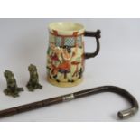 A silver mounted Rattan walking stick, a novelty musical pottery tavern mug in working order and a