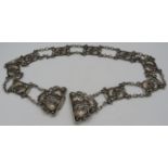 A fine Art Nouveau stylised silver belt with clasp, having nine panels each joined by links.