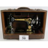 A vintage manual Singer sewing machine in later carry case, Serial No EC351496 Circa 1939. Condition