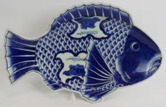 An antique Japanese porcelain blue and white dish in the form of a koi carp. Signed to base.