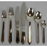 A seven piece place setting of Georg Jensen stainless steel pyramid pattern cutlery, all unused ex