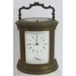 A good quality 19th century gilt brass repeater carriage alarm clock in ovoid engraved case. No