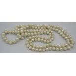 A string of freshwater pearls, 46" long, each pearl knotted through a very small hole. Each pearl