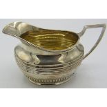 A silver cream jug gilded interior with banding & fluting decoration, Sheffield 1896, approx