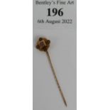 A Victorian 9ct gold stick pin of Quatrefoil form with central diamond, pin and top both marked 9ct.