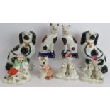 A pair of Staffordshire pottery cats, a pair of spaniel wally dogs, a pair of poodle bud vases, a