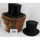 An antique leather hat box with original travel labels and containing a silk top hat and opera