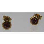 A pair of 15ct yellow gold stud earrings set with pink tourmaline, approx weight 1.6grams, boxed.