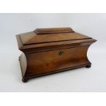 A 19th century rosewood sarcophagus tea caddy of good size with internal fittings and Bramah lock.