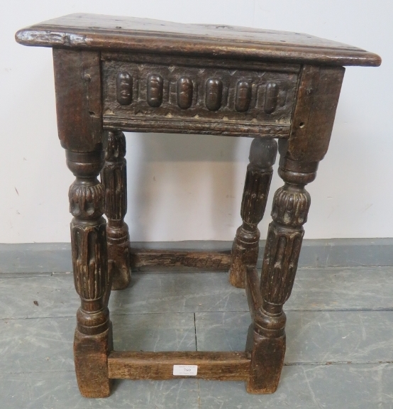 A fine late 16th century Elizabethan oak joint stool in unrestored condition, with carved frieze, o