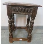 A fine late 16th century Elizabethan oak joint stool in unrestored condition, with carved frieze, o