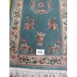A late 20th century Chinese thick pile rug on turquoise ground. 200cm x 92cm. Condition report: Good
