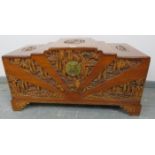 A vintage Japanese camphorwood trunk, with relief carving depicting pagodas amidst foliate scenes