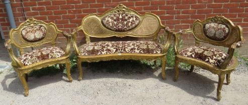 An antique French three-piece salon suite, comprising two giltwood open-sided armchairs and a two-