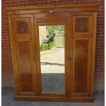 An Edwardian burr walnut & satin walnut triple wardrobe featuring dentil cornice and relief carved