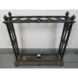 A 19th century cast iron stick stand by Coalbrookdale, with corner finials flanking six circular