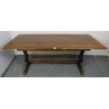 A vintage mid-century elm refectory table by Ercol, on shaped and pierced supports with central