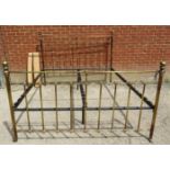 An antique style brass kingsize bed with ball finials and cast roundel detail to head and