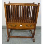 A Regency rosewood Canterbury, with spindle uprights and removable central divider, surmounted by