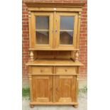 A vintage French pine kitchen dresser, the top with glazed cupboard and loose shelf, with cupboard