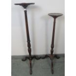 Two Edwardian Regency Revival mahogany torcheres, with reeded columns, on tripod bases with claw &