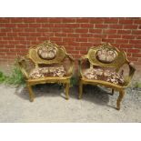 A pair of antique French giltwood open-sided armchairs with carved and pierced cornice,