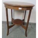 An Edwardian mahogany circular two-tier occasional table, on splayed supports. Condition report: