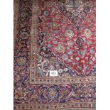 A fine Kashan carpet, central pattern blue on cream on claret field and blue ground. 3.10 x 2.00.