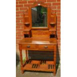 A reproduction fruitwood dressing table in the Victorian taste, with carved cornice and finials,