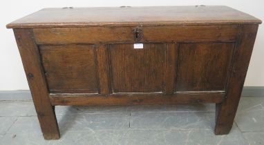 A late 17th century oak joined six plank coffer, featuring original hinges and later panelled front,