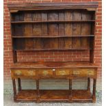 An early 18th century ash dresser/sideboard of excellent colour and patina, with plate rack shelving