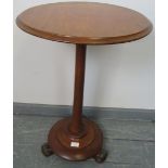 A Victorian mahogany circular occasional table, the tapering column on a plinth base with scrolled