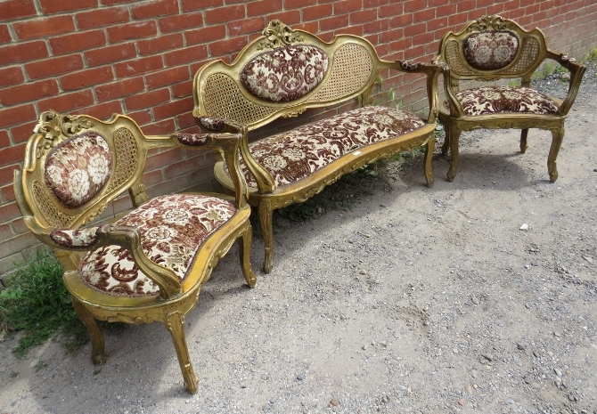 An antique French three-piece salon suite, comprising two giltwood open-sided armchairs and a two- - Image 2 of 2