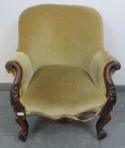 A 19th century mahogany framed parlour chair, with acanthus carved and scrolled arms, upholstered in