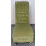 A Victorian mahogany slipper chair, upholstered in buttoned green velvet, on bun feet with ceramic