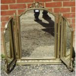 An antique style gilt gesso triptych mirror, the ornate surround with shell cornice and mythical