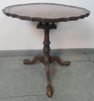 A George III style mahogany tilt-top ‘birdcage’ table with reeded column, on carved tripod base with