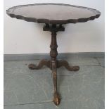 A George III style mahogany tilt-top ‘birdcage’ table with reeded column, on carved tripod base with