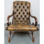 A mahogany framed slipper chair in the Regency taste, upholstered in deeply buttoned brown leather