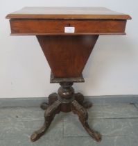 A 19th century mahogany and walnut trumpet/work table, the inlaid lid opening onto an array