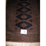 A mid 20th century Persian runner central repeat pattern on blue field with brown borders. 81cm x