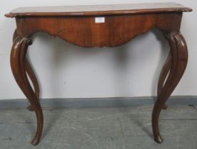 An 18th century and later French burr walnut crossbanded console table, with shaped apron, on