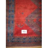 A 20th century Afghan rug, 3 central diamond motifs and 8 symbols hammer and sickle. 149cm x