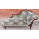 A late Victorian mahogany chaise longue, upholstered in a patterned green velvet type material, on